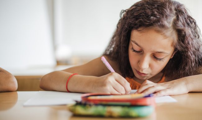 schoolgirl-holding-pen-drawing